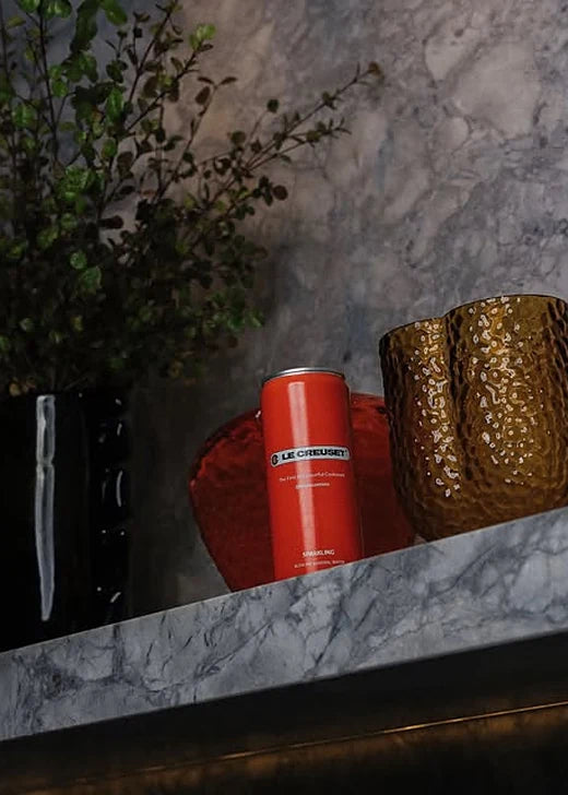 A Le Creuset custom branded Rippl can on a marble shelf