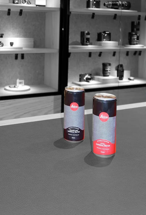 Leica cans on the counter of a Leica store