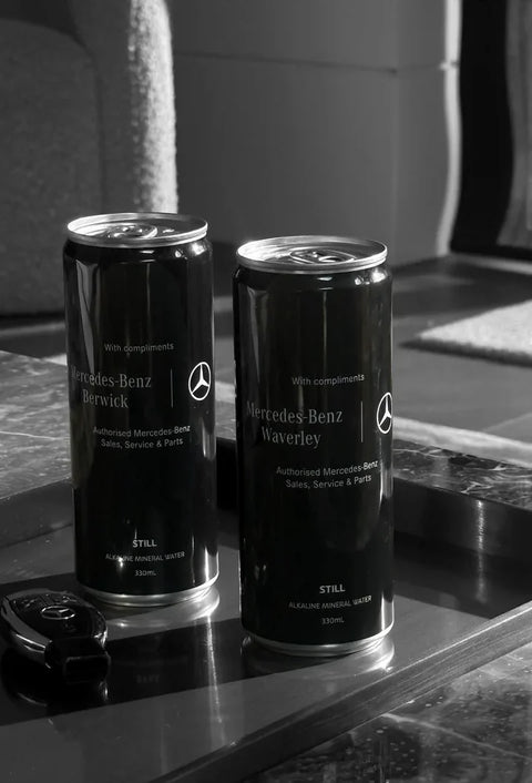 Mercedes-Benz cans on a tray beside a car key