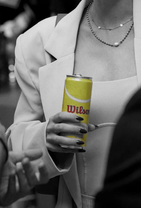 A Wilson can in hand at an event